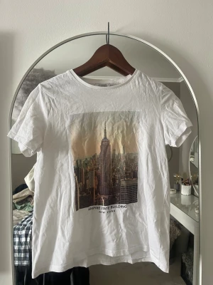 Vit Empire State Building t-shirt - Vit t-shirt väldigt fin till sommaren har använt den nån gång men inte ofta 