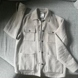Overshirt/jacka från visual clothing project  - Beige overshirt/jacka från visual clothing project. Perfekt till höst och sena kvällar. 