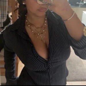 Svart randig skjorta  - Svart skjorta med vita smala ränder.