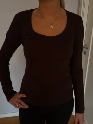 Mörkbrun långärmad topp - En basic mörkbrun långärmad topp med rundad urringning. Materialet är mjukt och stretchigt. 🤎🤎