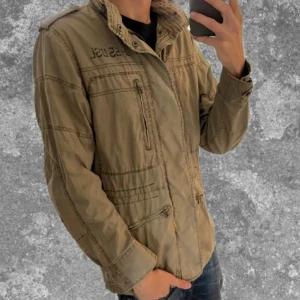 Beige/olivgrön Fieldjacket  - Snygg och clean field jacket från Fifty Five DSL 💫 Perfekt lätt jacka med lite utility-vibe – sitter sjukt bra och funkar året runt. Färgen är en nice mix mellan beige och olivgrön som passar till allt 👌  📏 Storlek: M ⚡️ Skick: Mycket bra