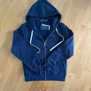 Mörkblå Ralph Lauren Zip storlek S - Säljer denna mörkblåa ralph lauren kofta i storlek S-M. Det står L på insidan men den passar mest dels S. Väldigt skönt material på insidan! Säljer även en likadan i svart så kolla profilen!
