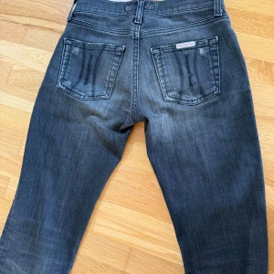 Mörkgrå jeans från Fornarina - Snygga mörkgrå jeans från Fornarina med slitna detaljer och klassisk femficksdesign. Jeansen har raka ben och subtila slitningar på både fram- och baksida för en cool, avslappnad look. Tillverkade i mjukt jeanstyg som sitter skönt hela dagen.