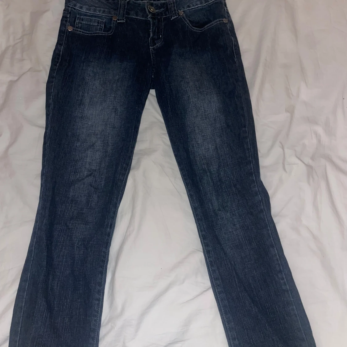 Mörkblå jeans med broderade bakfickor