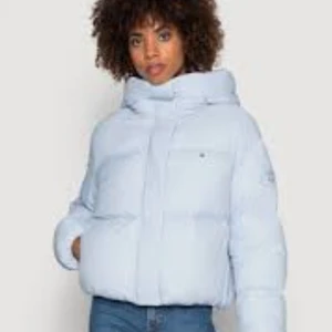 Ljusblå pufferjacka Tommy Hilfiger XL - Säljer en ljusblå pufferjacka från Tommy Hilfiger i storlek XL. Passar L och tom lite större M. Jackan har hög krage, dunfyllning och en clean design med diskret logga på bröstet. Perfekt för kalla dagar och har långa ärmar samt dragkedja framtill.