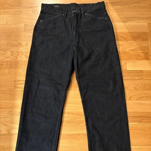 mörkblå jeans straight fit - Säljer ett par klassiska zara jeans i mörkblå tvätt med rak passform. Jeansen har fem fickor, knappgylf och snygga kontrastsömmar. Perfekt för dig som gillar tidlös stil och vill ha ett par jeans som funkar till allt.