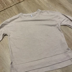 Beige långärmad tröja från Hanes - Säljer en enkel och stilren beige långärmad tröja från Hanes i storlek XS. Tröjan har rund hals och breda ribbade muddar vid hals och nederkant. Perfekt för dig som gillar en clean och chill look.