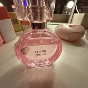 Ariana Grande parfym, 2 st - Snygg parfym från Ariana Grande med rosa flaska och fluffig boll. Perfekt accessoar på sminkbordet och populär bland unga. Volym och ingredienser syns ej på bilderna.