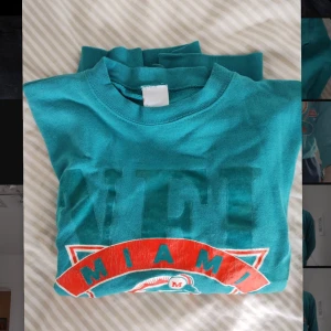 NFL sweater  - Skick:6/10 Modell: Herr/Unisex Storlek: M/L Schysst vintage "Miami Dolphins" NFL tröja i relativt bra skick. Den enda defekten är två hål i den ena ärmen men i övrigt en fräsch tröja. Passar in på Y2K/ skate/ streetwear stilen. Frågor? Hör gärna av er!:) 