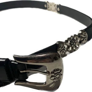 Bälte - Snyggt bälte med silvriga rosdetaljer. Har en liten skada som syns på tredje bilden, men det märks inte när man har på sig det