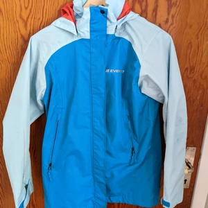 Rain jacket  - Kids size but fits an 8. Nice orange lining inside. Haven't had any issues with it although had for a few years. Fully waterproof!! 