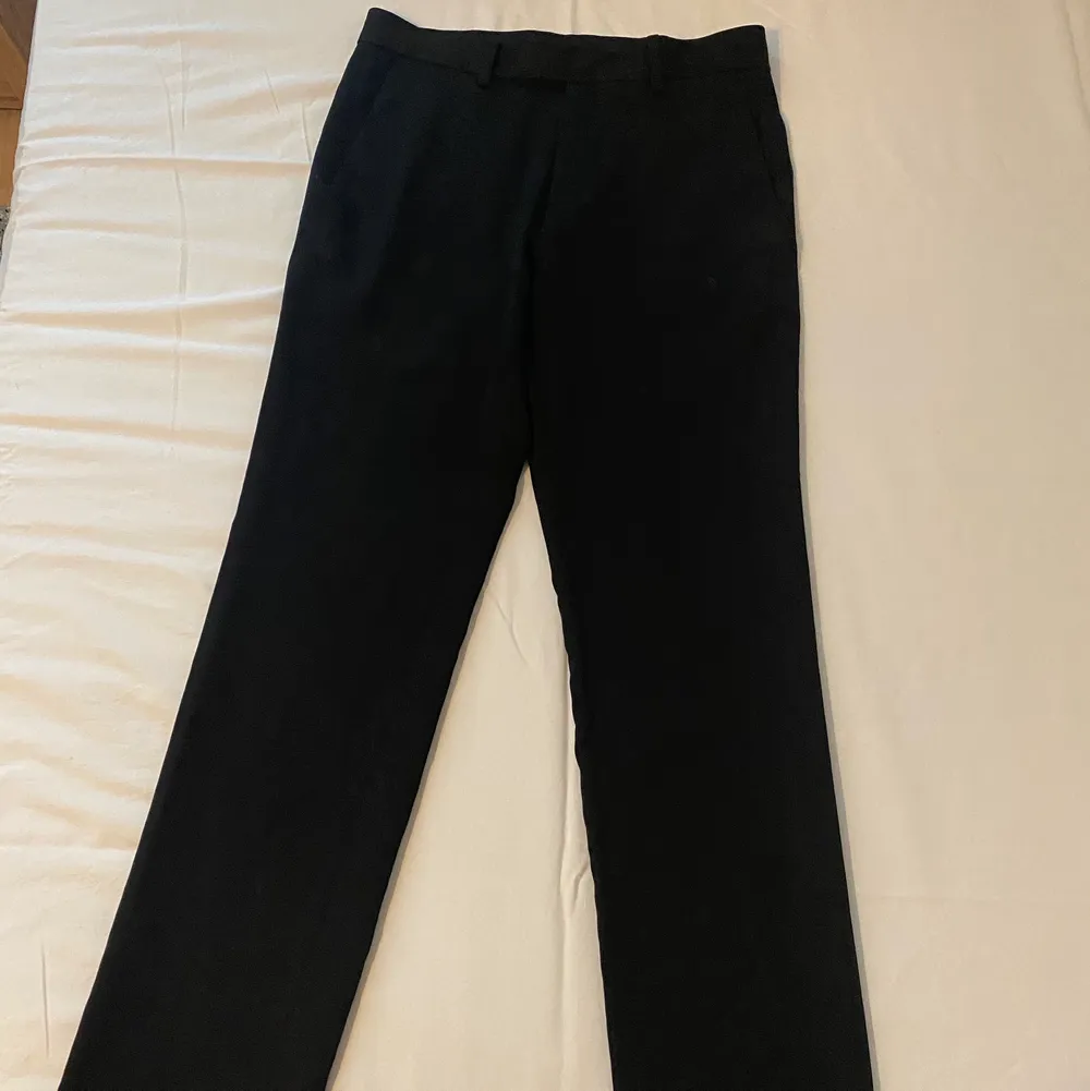 Svarta kostymbyxor från märket Kenneth Cole Reaction (köpta second hand) i storleken W30 L30. Säljer då jag har för många kostymbyxor och dessa är lite för stora i midjan och tajta på benen. . Jeans & Byxor.