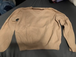 Beige v- ringad stickad tröja - Säljer nu min jättefina stickade tröja som är beige och v-ringad