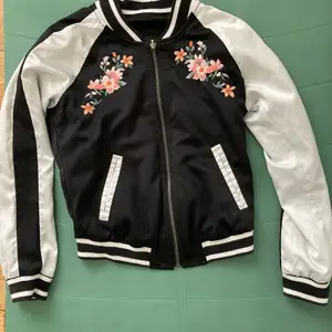 Barely worn as it is not my style. The jacket is reversible and has funky flowers on one side