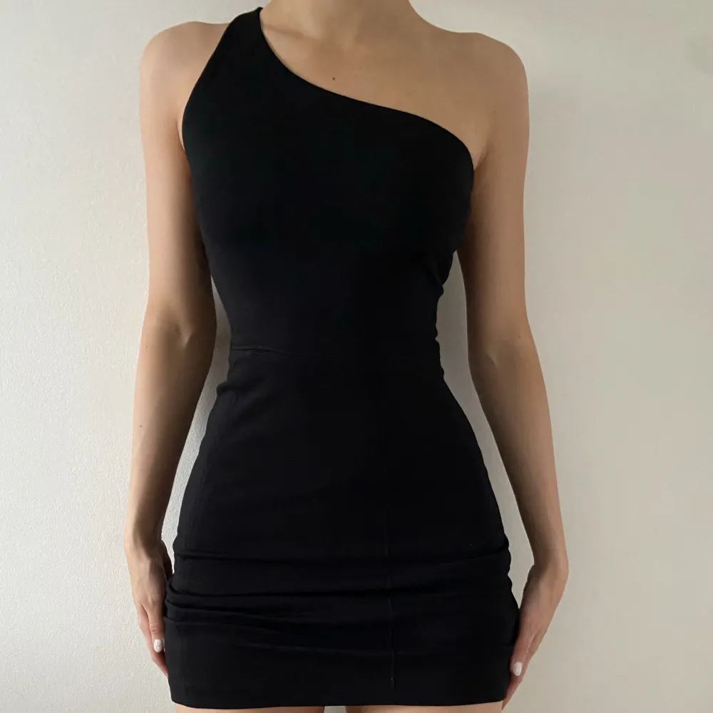 Bodycon klänning med en axel i svart.  Tjockt tyg, inte genomskinlig. Dragkedja på sidan. Passar xs/s.  Använd en gång. Nypris: 600 kr Säljer för: 300 kr. Klänningar.