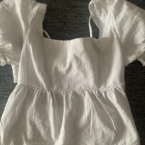 Topp - En jätte fin vit topp till sommaren! Inte så mycke använd så i bra stick, och har fina knytt på ryggen som man ser på bilden💕