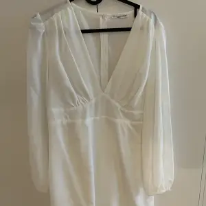 En vit klänning som sitter tajt över kroppen, superfin!! Storlek 40!! 