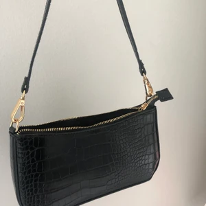 Väska  - Svart väska som är köpt på NEW YORKER för 119kr. Den har bara använts 1 gång till årets skolavslutning. Kan mötas upp och säker frakta ifall du bor långt bort