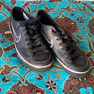 Svarta vintage Nike skor🤍 - Stl:39💓 Vintage svarta Nike skor som inte kommit till användning! Köpta för 450 kr!! Nyköpta från beyond retro, är i superfint skick med nya snören och bra sömmar! Kan mötas upp i antingen Lund eller Malmö! Om du har några fler frågor om skorna eller vill se en viss bild på skorna är det bara att kontakta mig! Modellen påminner om Nike Court vintage modell! Köpare står för frakt<3