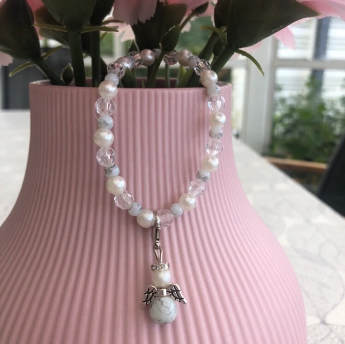 Armband med en avtagbar lyckoängel