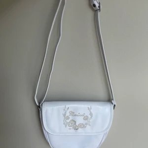 Vit väska - Vit väska med reglerbart band. Väskan är lite äldre, så derför är den lite sliten. Väskan har tre olika fack. Köpte den för 399kr