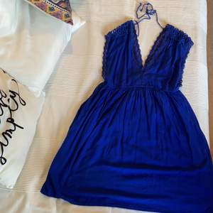 Pretty short blue dress with floral details and open back.