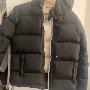 Dunjacka Dbrand  - Säljer min D brand jacka som har hängt med under 2 vintrar. Jackan är i stl M men skulle säga att den även passar S . Säljer jackan pga att den ej används något mer. Lite slitet på ytan samt missfärgning på insidan men ingeting som är trasigt. (Rekomenderar att tvätta den för att bli av med smutsen på insidan)