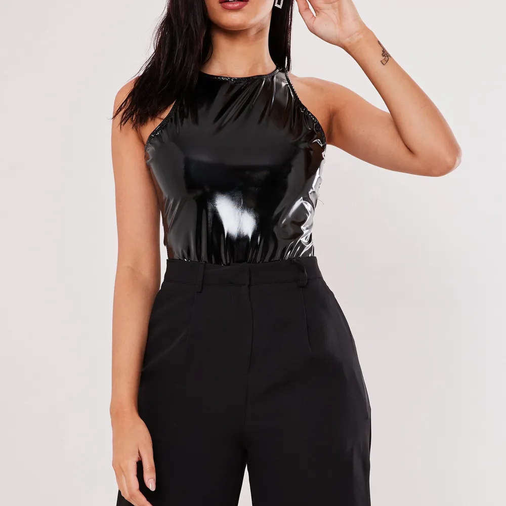 En bodysuit inköpt från Missguided i lack/vinyl material, endast provat med lapp kvar. Storlek 36, UK 8. . Toppar.