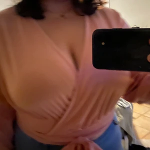 Rosa knyttröja - Rosa tröja med långt snöre som man snurrar några varv sen knyter, fin ljusrosa färg, använd 1 gång