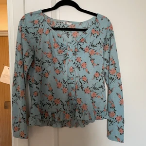 Blommig långärmad blus - En fin blommig långärmad blus med knappar framtill 