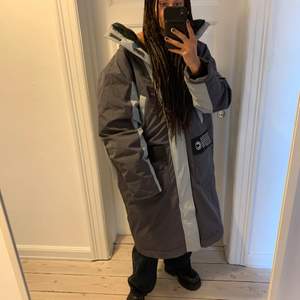 Hyper modern experimental puffer coat. 4 arms and can be worn several ways e.g. with a grey front or a olive front. 2 detchable hoods, several pockets. Very warm. Good condition