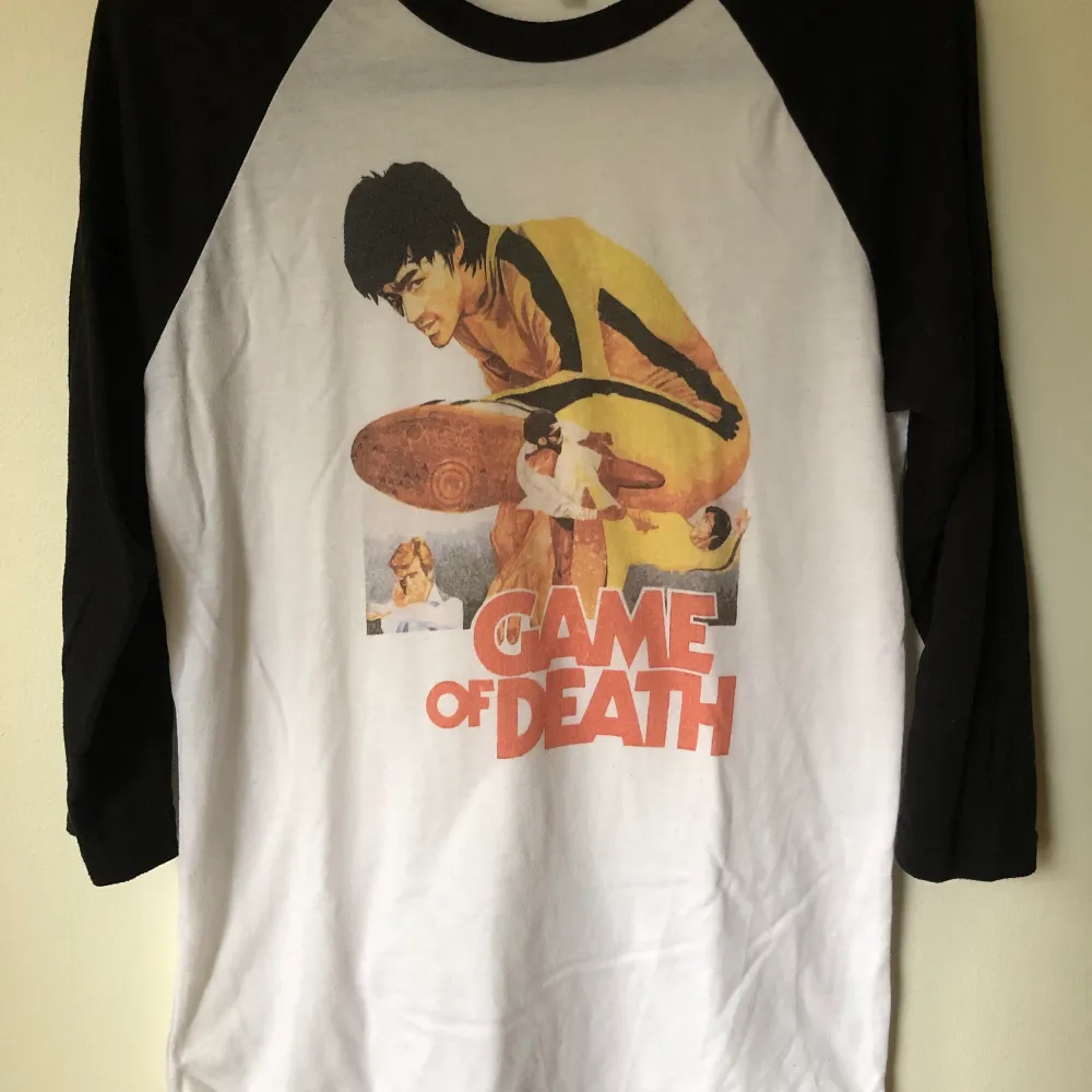 Retro Bruce Lee Game Of Death Baseball T-Shirt Size small, fits like a regular men’s size small.  Excellent condition, no flaws or damage.  DM if you need exact size measurements.   Buyer pays for all shipping costs. All items sent with tracking number.   No swaps, no trades, no offers. . T-shirts.