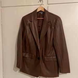 Brun skinnblazer  - Oanvänd NY brunn skinnkavaj. Prislapp  fortfarande på. Storlek 40, vilket passar för dig som är en 40, men för en mer oversize fit skulle jag säga att du som är en 36a eller mindre. Köparen står för frakt 