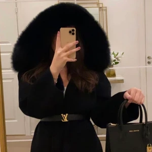 Kappa med pälskrage  - Svart kappa i storlek Xs men är oversized passar även S möjligtvis liten M från femeninaofsweden inga skador på jackan jag står ej för frakt. lv bältet på bilden tillhör ej.