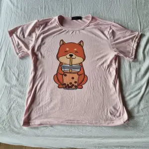 Rosa, gullig t-shirt med tryck av en shiba som dricker boba tea. Storlek M, från kawaii.se. Knappt använd.