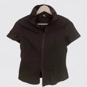 GRÅ TRÄNNINGSTOPP - grå träningstopp man kan justera båda ändarna av dragkedjan på, skön och tunn. Helt ny 