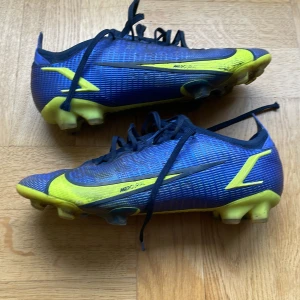 Nike mercurial vapor 14 elite  - Fotbollsskor i mycket bra skick. Nytt pris 2799. Väldigt bra sko fungerar lika bra första användning som nu. Lite slitna vid hälen och längst ut på snören. Kommer med en speciell sula. Säljer pga för små. Pris kan diskuteras. 