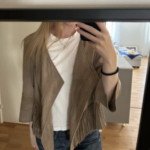 Jacka - Säljer denna as coola läderjacka med fransar. Den är beige brun i färgen och har trekvartslånga ärmar. Skriv i dm vid frågor🪩🪩