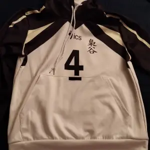 A black, white and yellow hoodie made out of polyester. From the anime haikyuu.