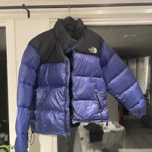 The North Face Puffer Blå - Använd The North Face puffer. Storlek S men passar även M. Har ett litet hål på vänster arm, men är inte jättesynligt.