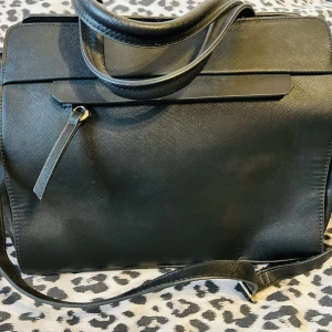 dam väska med axelrem i skinn - Super fin dam väska med axelrem i skinn. Färg: svart skinn.  Innre och yttre fack finns.   Ej använd