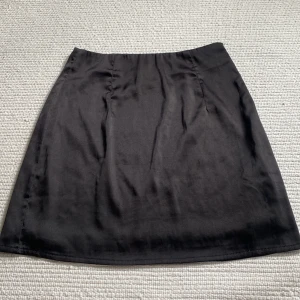 Kjol - Svart kjol i silkesmaterial, från missguided men köpt på nellys hemsida. Storlek 34, passar Xs/S💕 Fint skick, köparen står för frakt! 