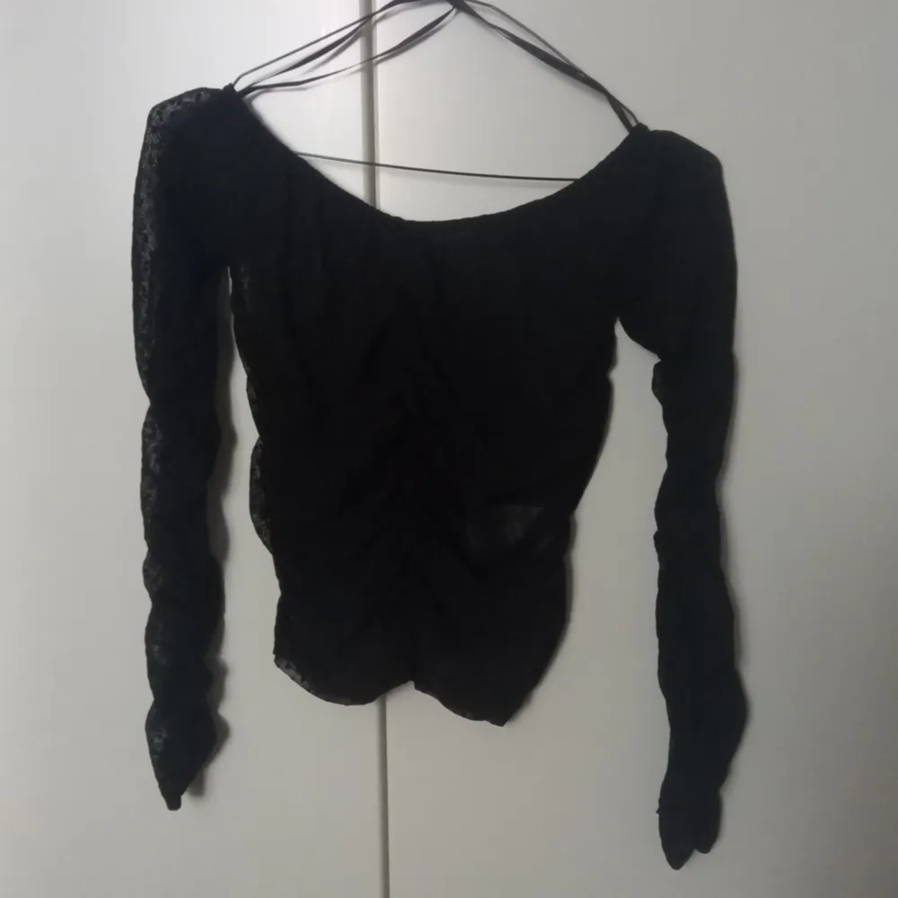 Black ruched mesh top with dots. Size XS. Shipping is not included. . Toppar.