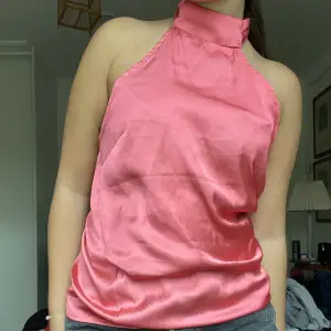 Rosa satin festtop från Gina tricot. Den är halterneck och går att knyta i nacken. Köpt för ett tag sen men knappt använd.  