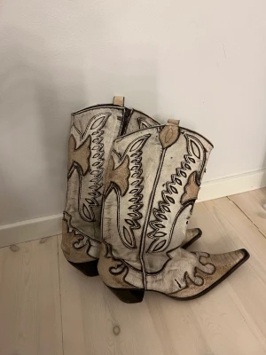 Cowboystövlar  - Vita och bruna cowboystövlar med dragkedja och klack 