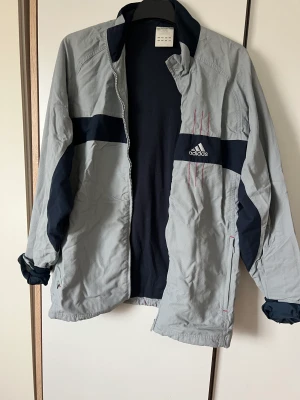 Adidasjacka - Skitsnygg adidasjacka, köpt secondhand men har aldrig använt själv. Storlek typ M om man vill ha den lite oversize. Lite lösa trådar på ryggen man kan klippa av