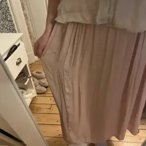 Rosa lång kjol i ett otroligt (!!!!) skönt tyg! Fint skick! (läs gärna bion för mer info)