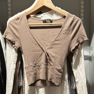 brun/ beige omlott topp  - som sitter supersmikrande på kroppen 