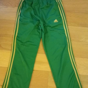Gröna Adidas byxor - Ett par gröna byxor som är jätte skörna. Dom är ganska högmidjade. Det finns några små hål men enkelt att sy igen men dom syns knappt💚💚
