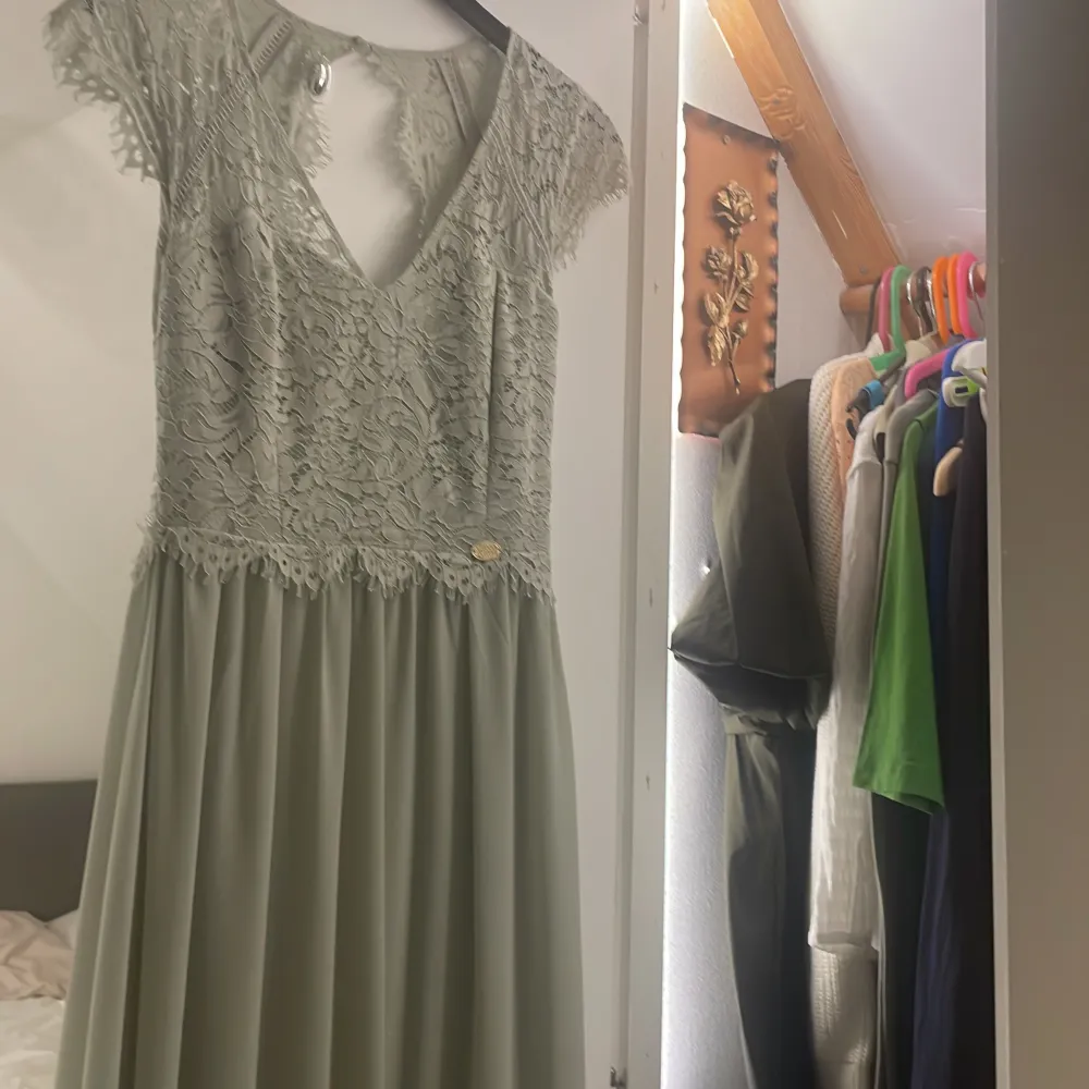 Klänning som bara är använd under ett bröllop,inga skador och är köpt för 1700,den är öppen rygg och är v ringad,andra bilden visar hur lång klänningen är den är perfekt i längd för mig som är 165❣️. Klänningar.